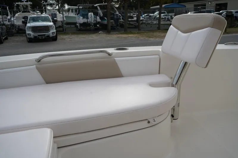 Slide: The Image of 2020 Robalo 226 Cayman boat seating area with white cushioned seats. - 16