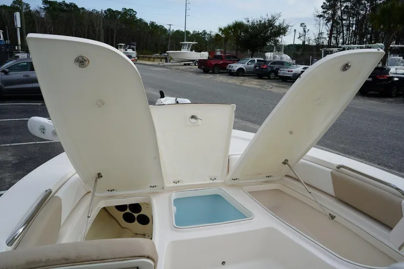 Slide: The Image of 2020 Robalo 226 Cayman boat with open storage compartments and seating area. - 17