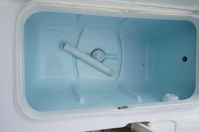 Slide: The Image of Livewell compartment of 2020 Robalo 226 Cayman boat, featuring a clean interior. - 4