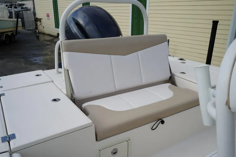 Slide: The Image of 2020 Robalo 226 Cayman boat interior with cushioned seating and storage compartments. - 7
