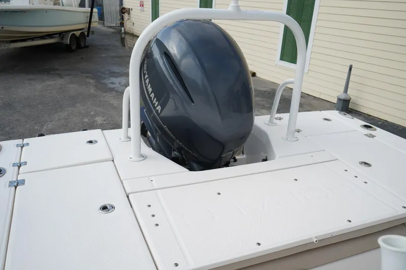 Slide: The Image of 2020 Robalo 226 Cayman boat with Yamaha outboard engine, docked near a building. - 8