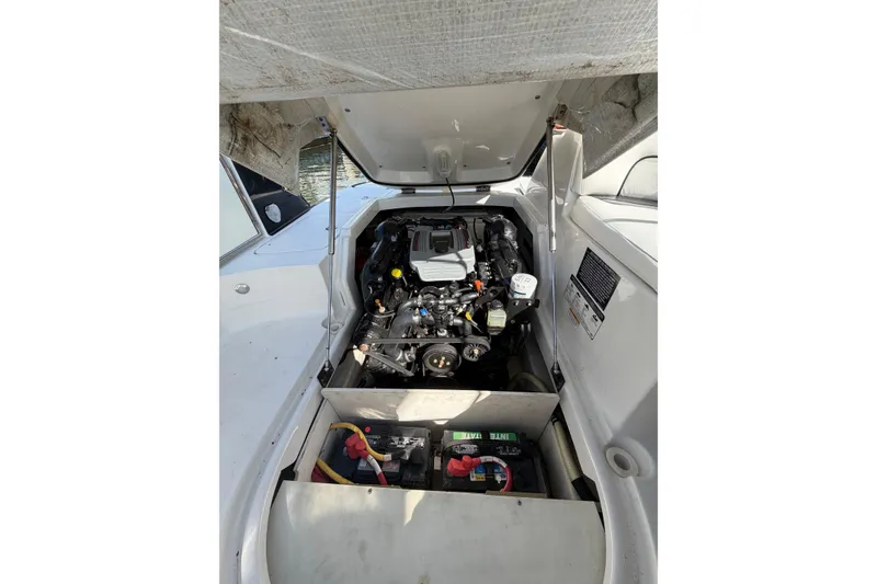Slide: The Image of 2015 Monterey 264FS boat engine compartment with visible battery and components. - 10