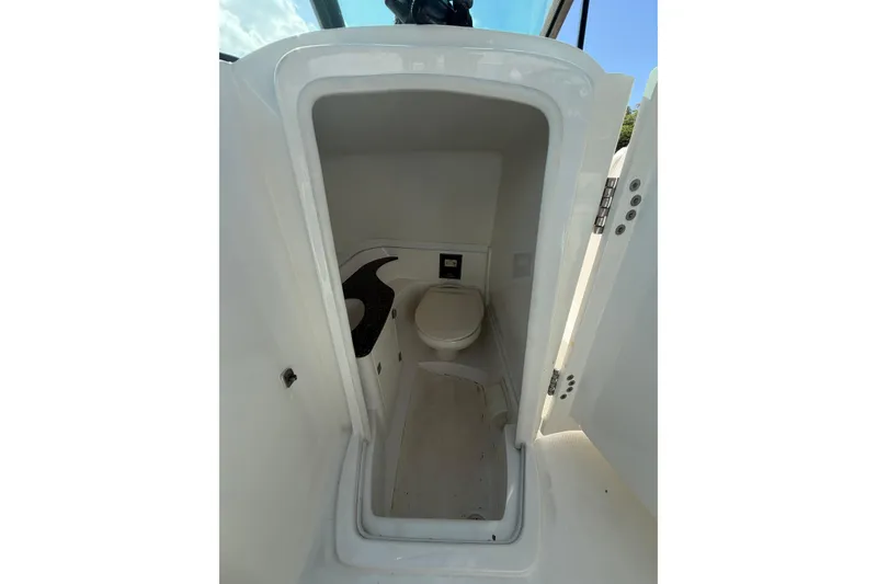 Slide: The Image of 2015 Monterey 264FS boat interior with compact marine toilet. - 9