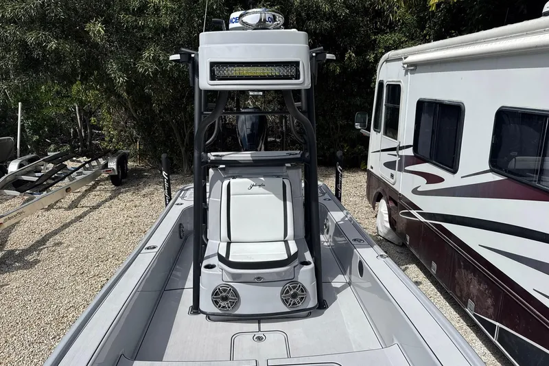 Slide: The Image of 2026 Yellowfin 24 Bay CE boat parked beside an RV, showcasing sleek design. - 4