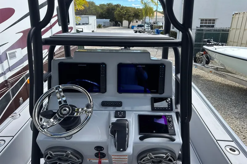Slide: The Image of 2026 Yellowfin 24 Bay CE boat dashboard with dual Lowrance displays and steering wheel. - 5
