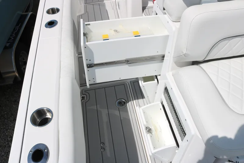 Slide: The Image of 2026 Sea Fox 282 Hybrid LT boat interior with white seating and storage compartments. - 12