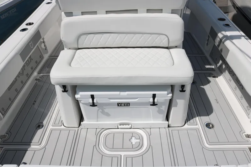Slide: The Image of 2026 Sea Fox 282 Hybrid LT boat interior with cushioned seating and Yeti cooler. - 13