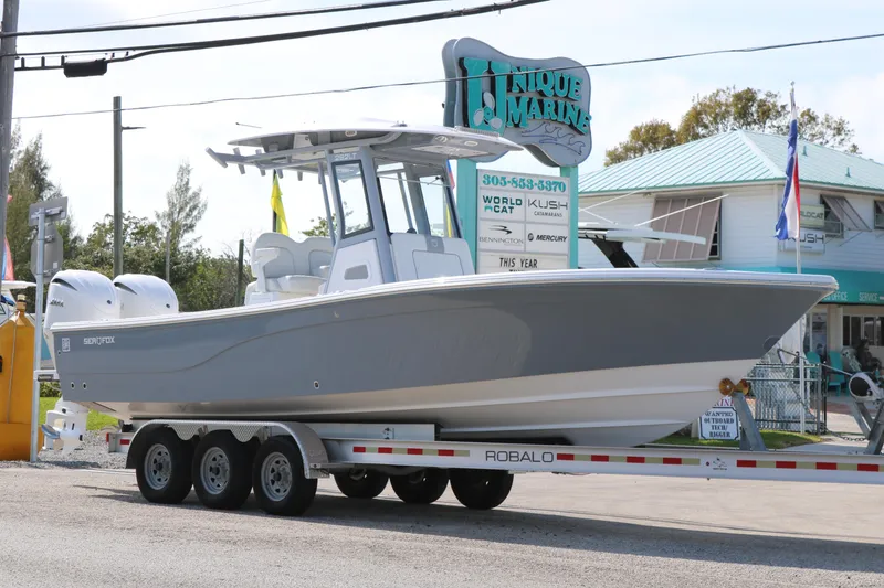 Slide: The Image of 2026 Sea Fox 282 Hybrid LT boat on trailer at Unique Marine dealership. - 3