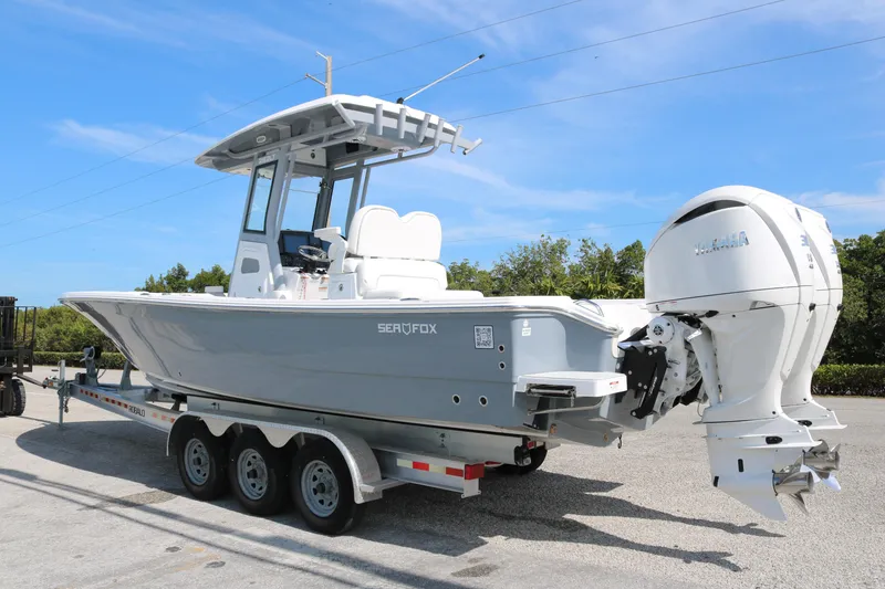 Slide: The Image of 2026 Sea Fox 282 Hybrid LT boat on trailer, featuring dual outboard engines. - 5