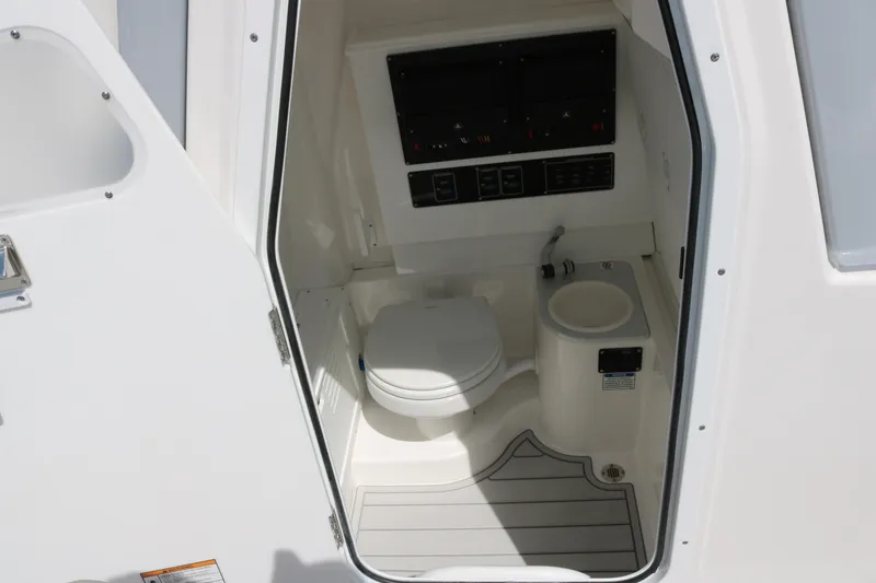 Slide: The Image of Interior of 2026 Sea Fox 282 Hybrid LT boat, featuring a compact marine toilet. - 8
