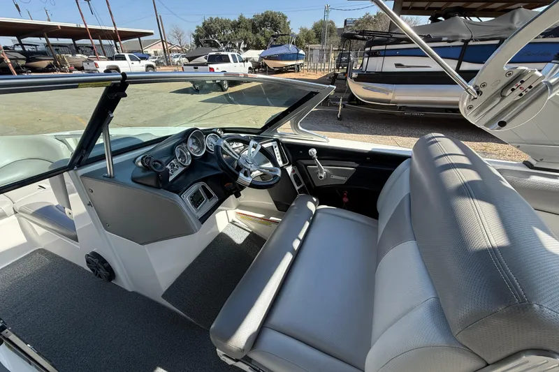 Slide: The Image of 2016 MasterCraft X46 boat interior with steering wheel and dashboard controls. - 10