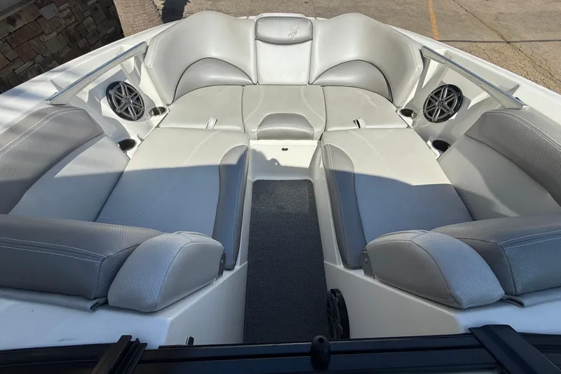 Slide: The Image of 2016 MasterCraft X46 boat interior with gray seating and built-in speakers. - 12