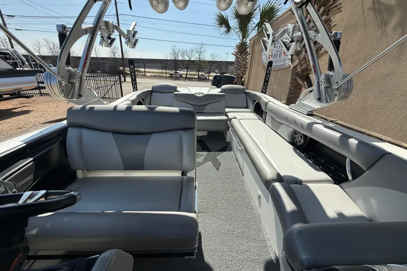 Slide: The Image of 2016 MasterCraft X46 boat interior with gray seating and advanced audio system. - 13