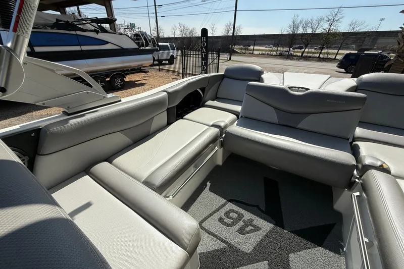 Slide: The Image of 2016 MasterCraft X46 boat interior with gray seating and carpeted flooring. - 14
