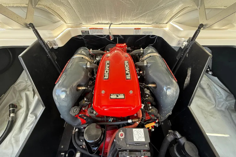Slide: The Image of 2016 MasterCraft X46 engine compartment with Ilmor engine, showcasing red and gray components. - 16