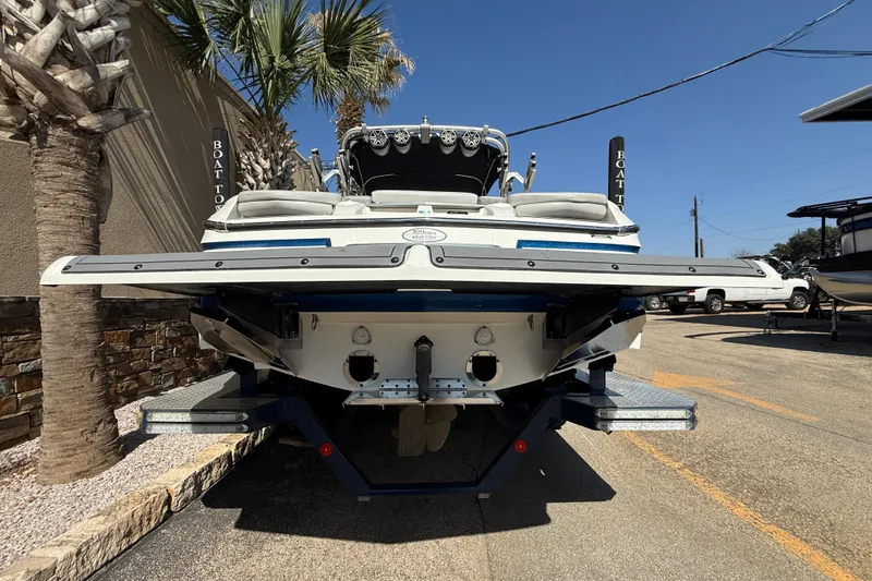 Slide: The Image of 2016 MasterCraft X46 boat rear view with swim platform, parked outdoors. - 7