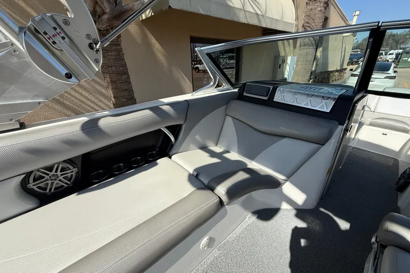 Slide: The Image of 2016 MasterCraft X46 boat interior with gray seating and speaker system. - 9
