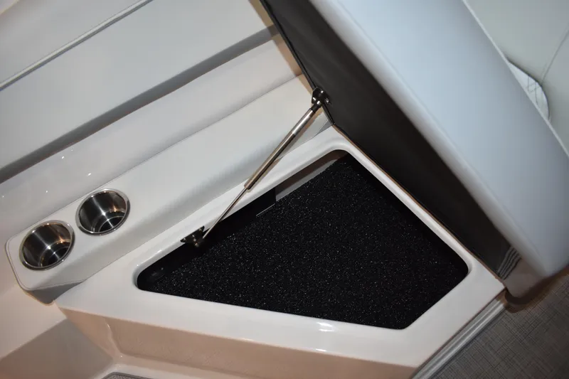 Slide: The Image of 2026 Regal 26 XO boat storage compartment with cup holders and hydraulic lift. - 11