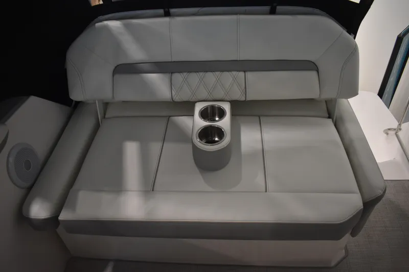 Slide: The Image of 2026 Regal 26 XO boat interior with cushioned seating and built-in cup holders. - 12