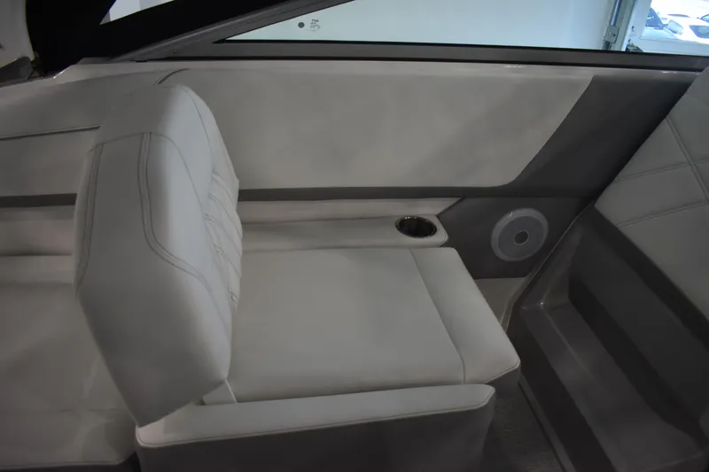 Slide: The Image of 2026 Regal 26 XO boat interior with white seating and built-in speaker. - 13