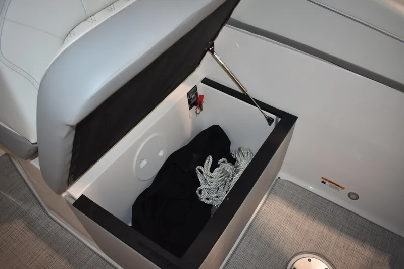 Slide: The Image of Storage compartment on 2026 Regal 26 XO boat with rope and black cover. - 18