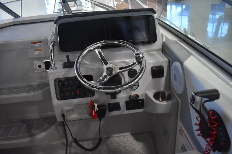 Slide: The Image of 2026 Regal 26 XO boat dashboard with steering wheel and control panel. - 20