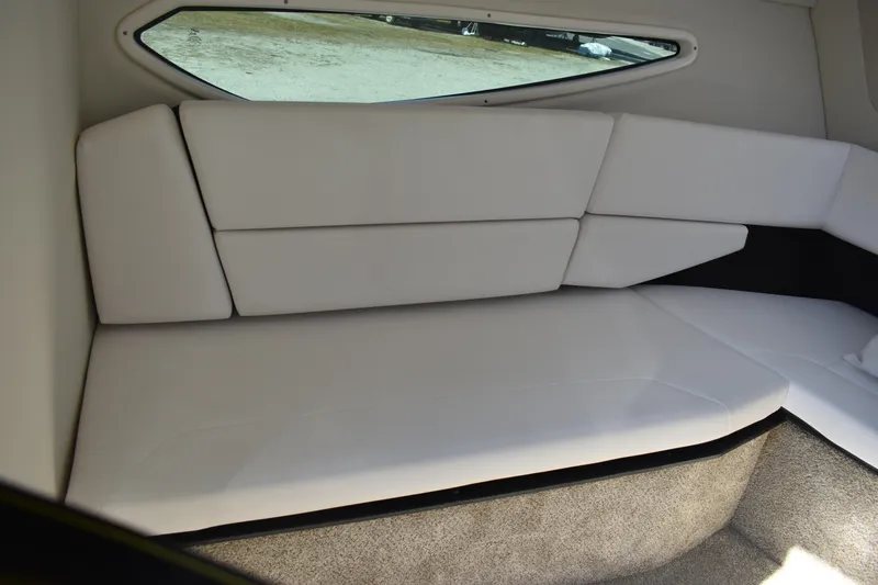 Slide: The Image of Interior cabin of 2026 Regal 26 XO boat with white cushioned seating. - 28