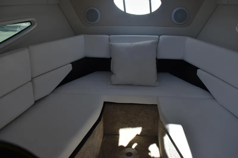 Slide: The Image of 2026 Regal 26 XO boat interior with white cushioned seating and circular window. - 29