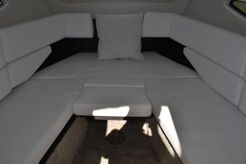 Slide: The Image of Interior cabin of 2026 Regal 26 XO boat with white cushioned seating. - 32