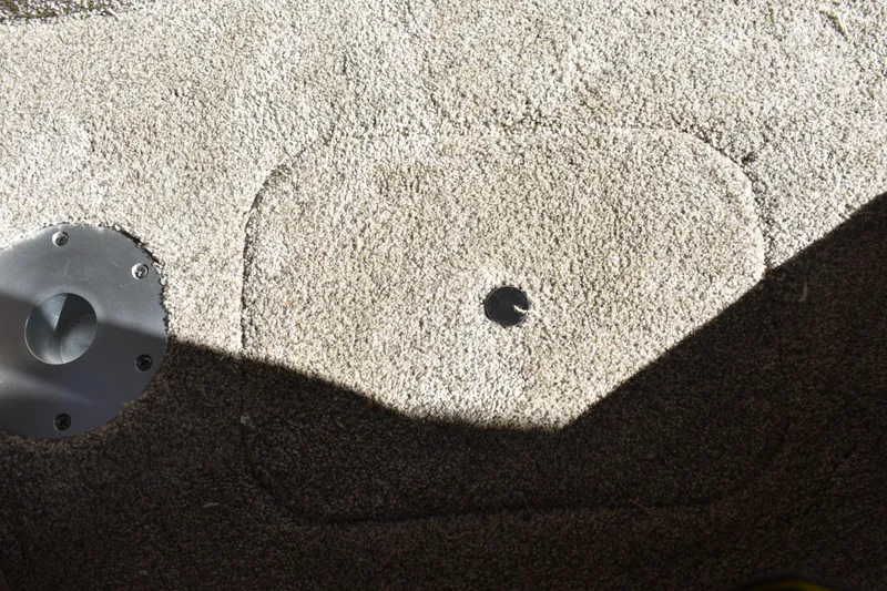 Slide: The Image of Carpeted floor detail of 2026 Regal 26 XO boat with metal fixture. - 35