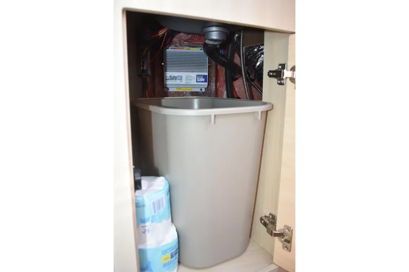 Slide: The Image of Storage compartment in 2026 Regal 26 XO boat with trash bin and supplies. - 40