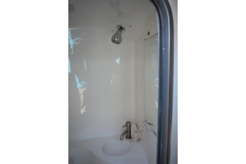 Slide: The Image of 2026 Regal 26 XO boat bathroom with showerhead and sink. - 47