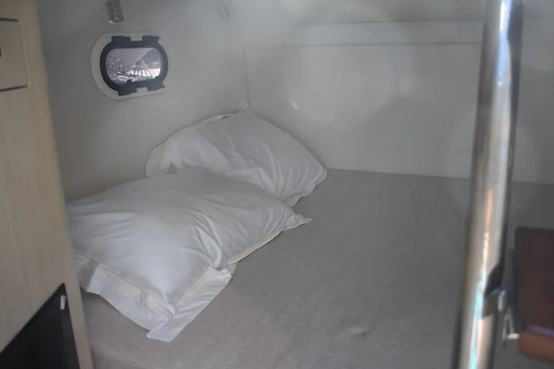 Slide: The Image of Cozy cabin interior of 2026 Regal 26 XO boat with pillows and porthole. - 48