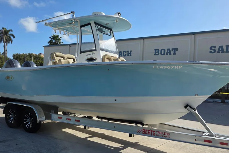 The Image of 2018 Sea Hunt Gamefish 27 boat on trailer, light blue hull, sunny day. - 0