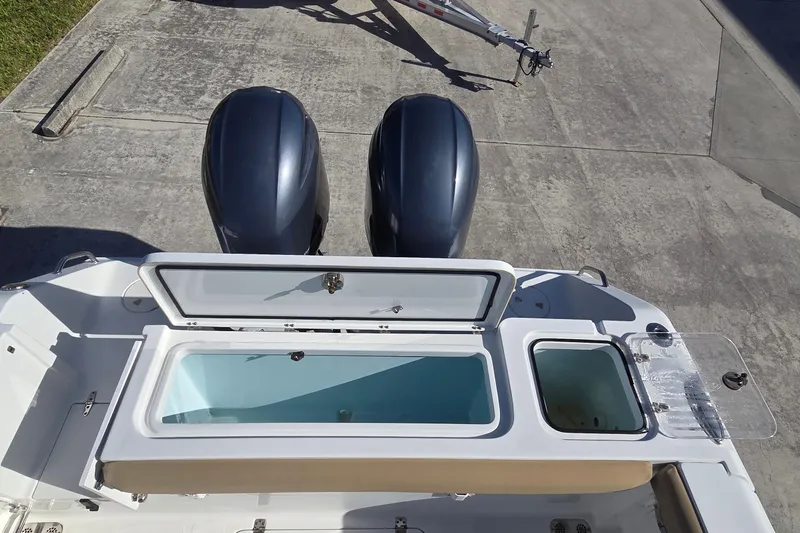 Slide: The Image of 2018 Sea Hunt Gamefish 27 boat with dual engines and open storage compartments. - 10