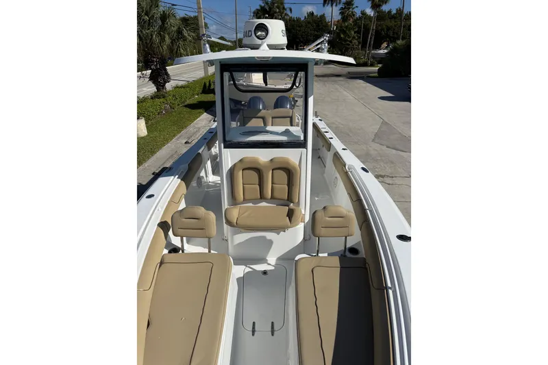 Slide: The Image of 2018 Sea Hunt Gamefish 27 boat with tan seating and sleek design. - 12