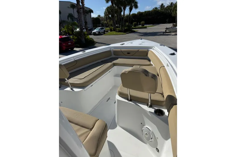 Slide: The Image of 2018 Sea Hunt Gamefish 27 boat interior with tan seating and spacious layout. - 24