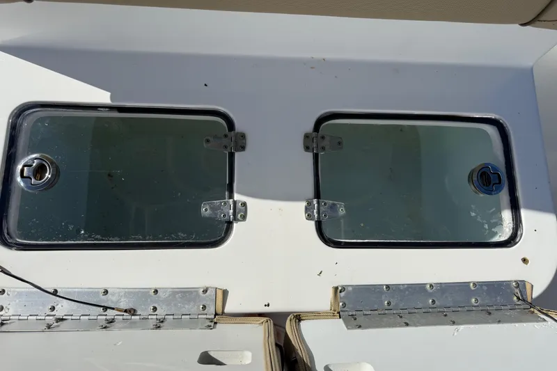 Slide: The Image of 2018 Sea Hunt Gamefish 27 boat storage compartments with metal hinges and latches. - 27