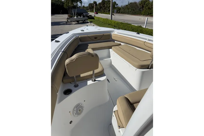 Slide: The Image of 2018 Sea Hunt Gamefish 27 boat interior with tan seating and spacious layout. - 3