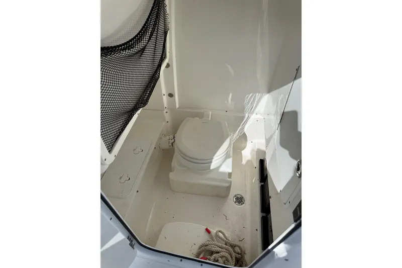 Slide: The Image of 2018 Sea Hunt Gamefish 27 boat interior with toilet and storage net. - 34
