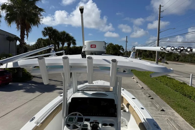 Slide: The Image of 2018 Sea Hunt Gamefish 27 boat with T-top and radar, parked on a sunny day. - 35