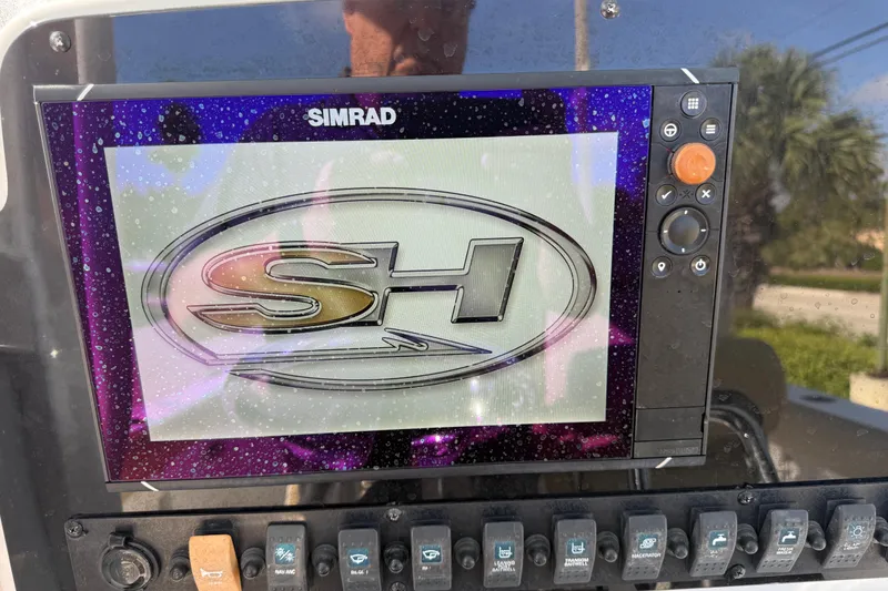 Slide: The Image of Simrad display on 2018 Sea Hunt Gamefish 27 boat dashboard with SH logo. - 36