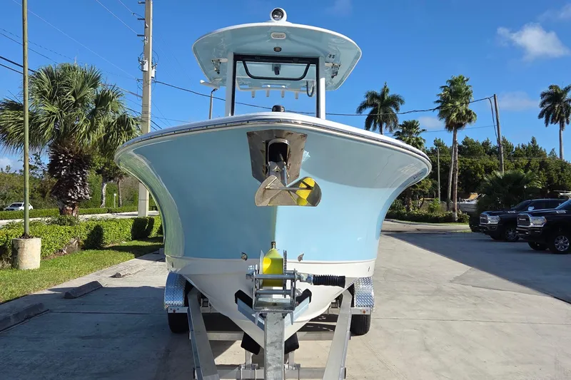 Slide: The Image of 2018 Sea Hunt Gamefish 27 boat on trailer, surrounded by palm trees. - 4