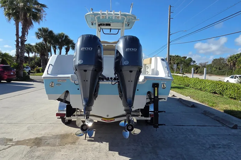 Slide: The Image of 2018 Sea Hunt Gamefish 27 boat with dual Yamaha 200 engines, parked outdoors. - 5
