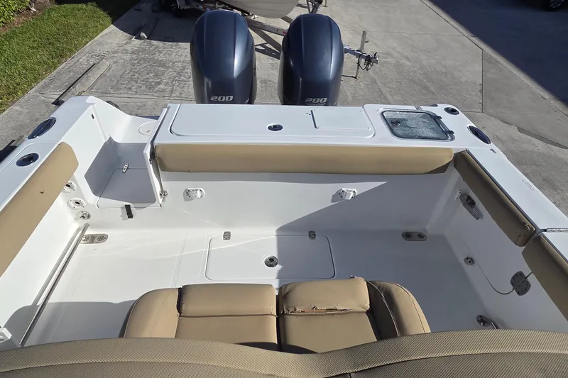 Slide: The Image of 2018 Sea Hunt Gamefish 27 boat interior with dual engines and cushioned seating. - 9