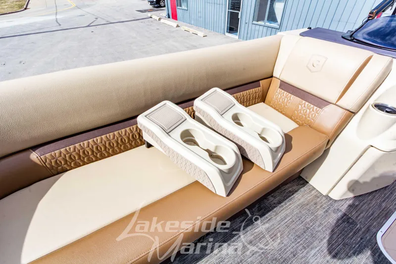 Slide: The Image of 2023 Godfrey Sweetwater 2286 FS boat interior with beige seating and cup holders. - 12