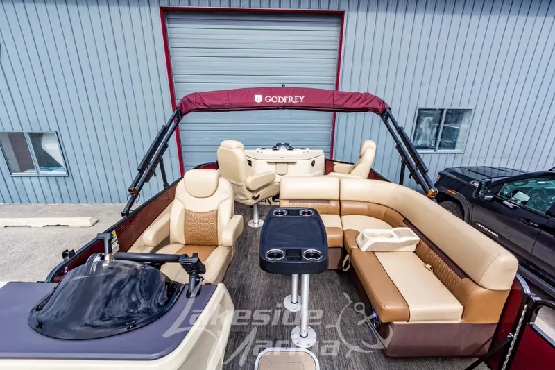 Slide: The Image of 2023 Godfrey Sweetwater 2286 FS pontoon boat with beige seating and maroon canopy. - 16