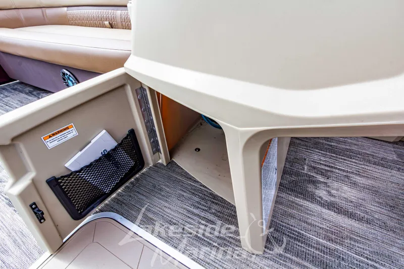 Slide: The Image of 2023 Godfrey Sweetwater 2286 FS boat interior storage compartment with open door. - 18