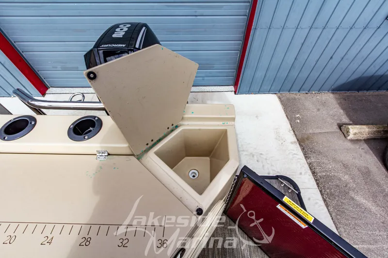 Slide: The Image of 2023 Godfrey Sweetwater 2286 FS boat with open storage compartment and Mercury engine. - 29