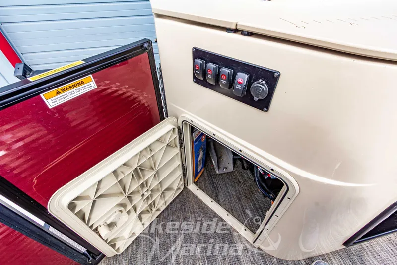 Slide: The Image of 2023 Godfrey Sweetwater 2286 FS boat control panel and storage compartment. - 31